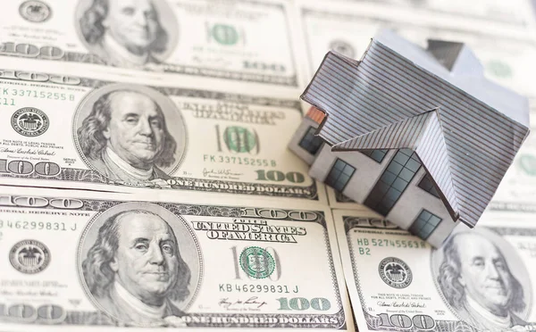 Miniature house with money on tax papers. High quality photo
