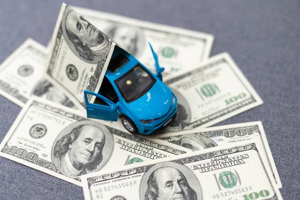 Toy car and money over white. Rent, buy or insurance car concept. High quality photo