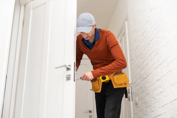 Young Handyman Installing White Door — Stock Photo, Image