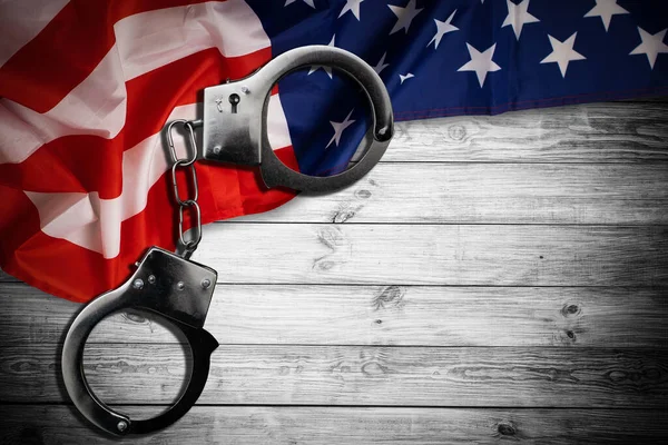 Police handcuffs on the USA flag, close-up. High quality photo