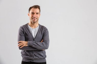 Confident and stylish. young man and looking at camera while standing against white background.