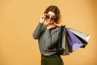 Portrait of happy beautiful shopaholic woman carry shopping bags, advertising concept isolated banner background.