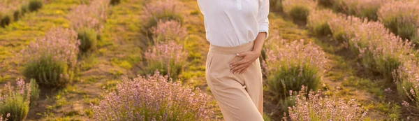 美しい若い健康な女性白いドレスは 夕日の光の下でわら帽子を保持ラベンダー畑を楽しく実行しています — ストック写真