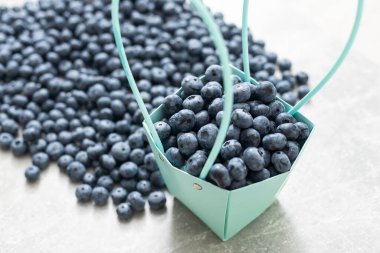 large blueberries in a green market basket.