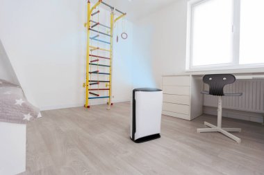Air purifier in cozy white living room for filter and cleaning removing dust PM2.5 HEPA and virus in home, for fresh air and healthy Wellness life, Air Pollution Concept.