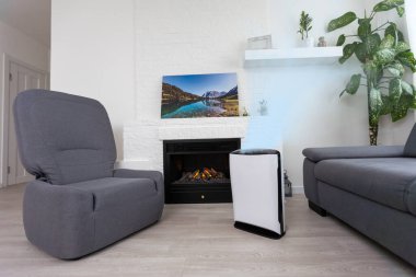 Air purifier in cozy white living room for filter and cleaning removing dust PM2.5 HEPA and virus in home, for fresh air and healthy Wellness life, Air Pollution Concept.