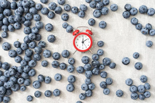 Time for seasonal berries and vitamins for a snack, breakfast, clock.