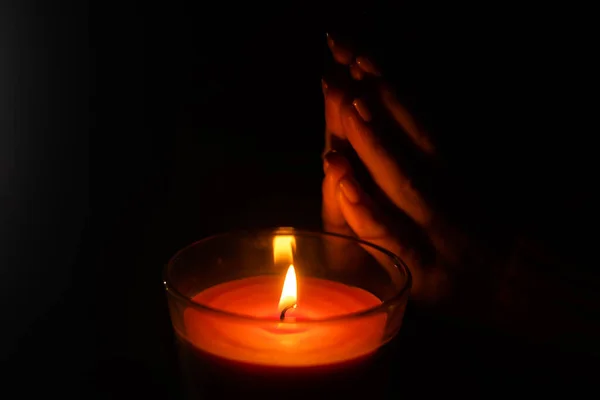 Woman Warms Her Hands Burning Candle — Stock Photo, Image