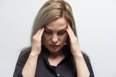 Young beautiful woman has headache isolated studio portrait