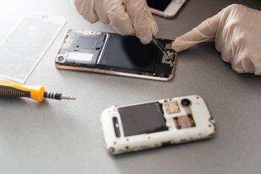 Onarım ve yeni yerine prepairing teknisyen ekran kırık ve kırık ekran smartphone masanın üzerinde prepairing.