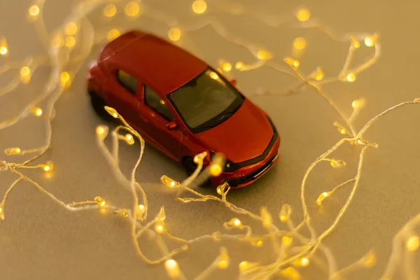 stock image toy car on christmas lights background. new year.