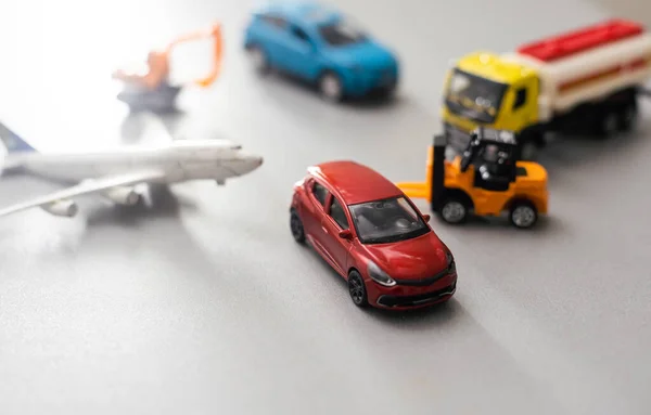 Figurine, toy car and toy airplane.