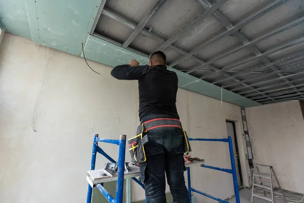 Construction worker installation ceiling work. High quality photo