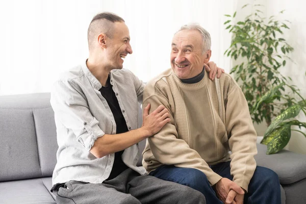 Young Adult Caucasian Son Listening Supporting His Old Elderly Senior — Stockfoto