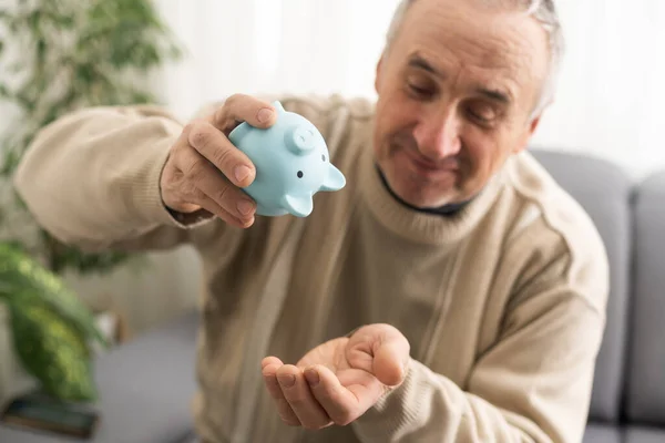 Elderly Man Holding Piggy Bank — Stockfoto