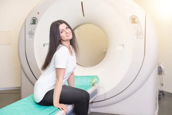 beautiful woman lying on ct scanner bed during tomography test in hospital.