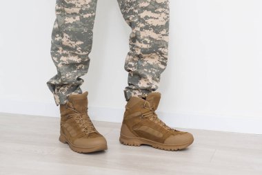 legs of a soldier in shoes.