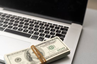 100 american dollar bills and computer keyboard.
