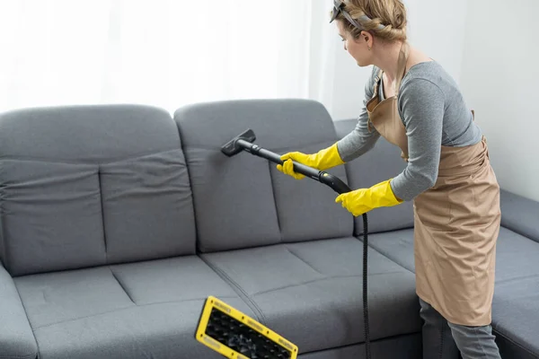 stock image Dry cleaners employee removing dirt from furniture in flat, closeup