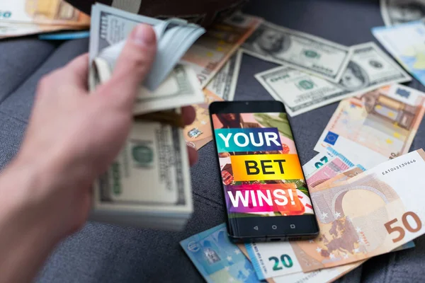 betting on sports, smart phone with working online betting mobile application.