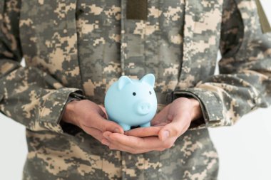 Soldiers Hand Holding Pink Piggy Bank. Save Income. clipart