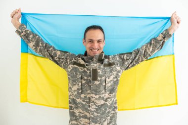 Ukrayna bayrağı taşıyan cesur Ukraynalı asker, özgürlük kavramı.