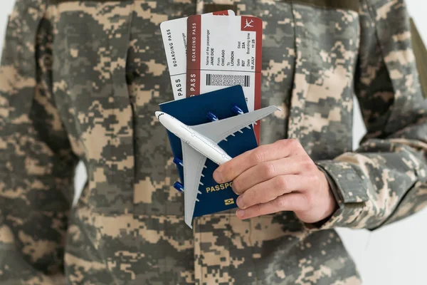 stock image military man holds passports and tickets.