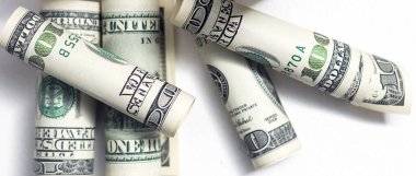 Roll of 100 dollar bills on background.