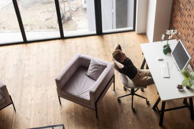 a woman with a computer working from home.