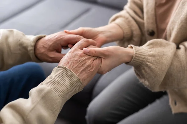 Young Woman Holding Senior Man Hands Closeup — Stock Photo, Image
