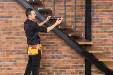 Home improvement handyman building staircase in a natural light. clipart