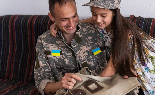 stock image Father in Ukrainian military uniform and his daughter. Family reunion.