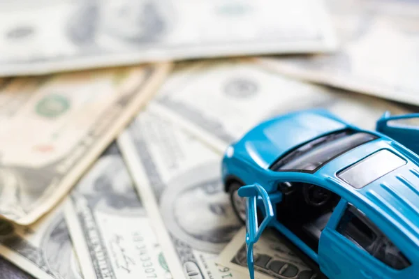 Toy car, money, documents. The concept of buying and insuring cars. Car, money.