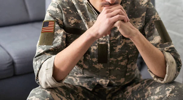 National American holidays. male praying soldier o with an American flag. Copy space. The concept of Veterans Day.
