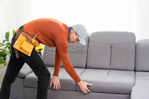 Man Repairing Sofa — стоковое фото