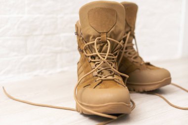 Fashion shoes with rough tread. Beige leather boots on laces for street style isolated on white background.