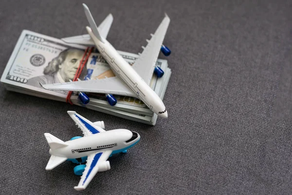 Toy plane and money on background. Travel insurance.