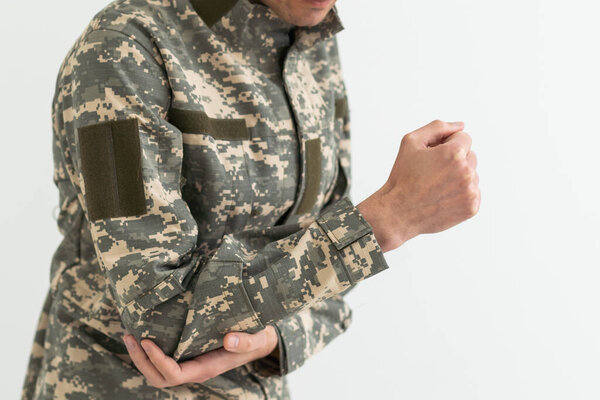 A military man has a pain in his arm