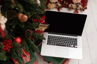 Laptop on background of Christmas interior.