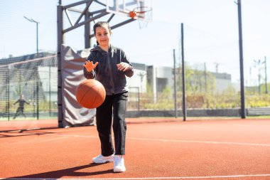 Güzel kız basket atıyor ve basketbol oynuyor..