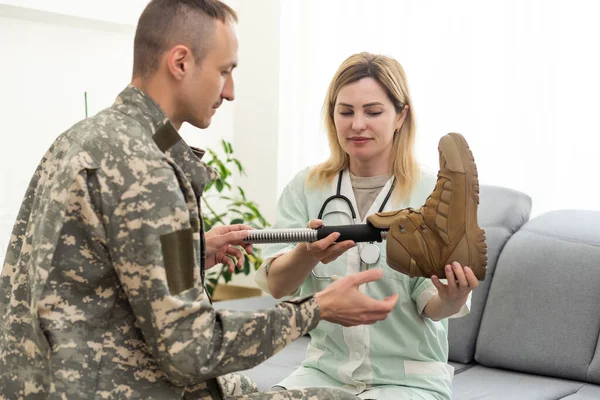 Portrait of military veteran fixing prosthetic leg and wearing army uniform, copy space. High quality photo