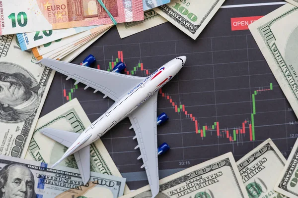 Toy plane on Euro cash background, travel with airplane. Conceptual image of the price of airline tickets for travel. Selective focue, close-up. High quality photo