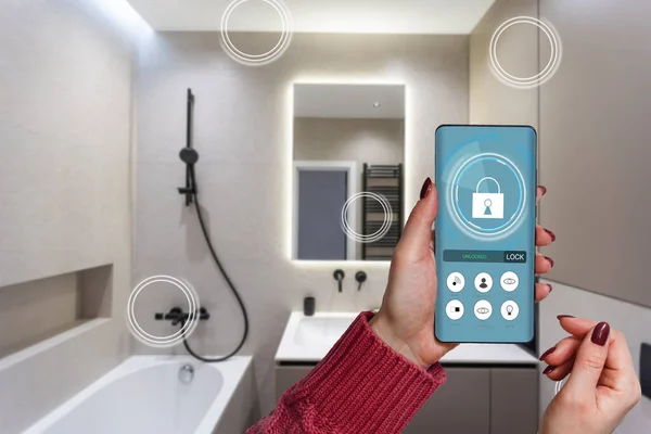 stock image Smart home technology, IoT Internet of Things interface on smartphone app screen connected objects in the modern apartment interior, woman holding device as remote control.