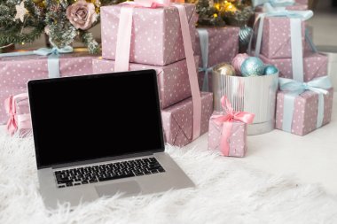 Laptop on background of Christmas interior.