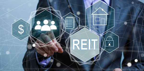 stock image REIT, Real Estate Investment Trust concept, Person hand using smart phone with Real Estate Investment Trust icon on virtual screen