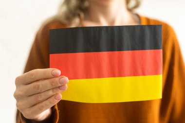 German flag in hands. Modern education, language learning and knowledge exchange