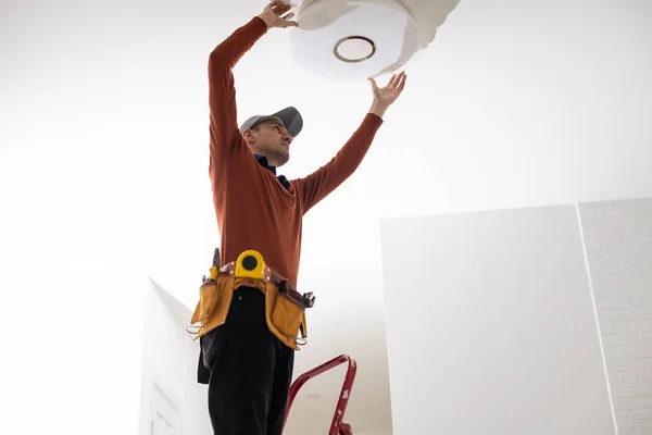 Electrician Uniform Repairing Ceiling Lamp Indoors — Stock Photo, Image