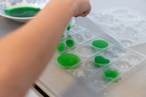 stock image Enthusiastic little girl doing home science project, having a eureka moment. She has chemistry glassware with colorful liquids.