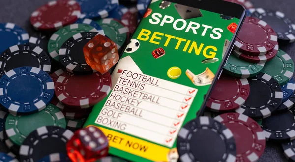 Mobile phone with bets, cards, chips, cubes and money dollars. Concept application for smartphone gambling, electronic casino online.