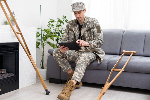 Telemedicine Concept. Military man Having Video Call With Therapist Using Digital Tablet, Getting Virtual Medical Consultation From Doctor.
